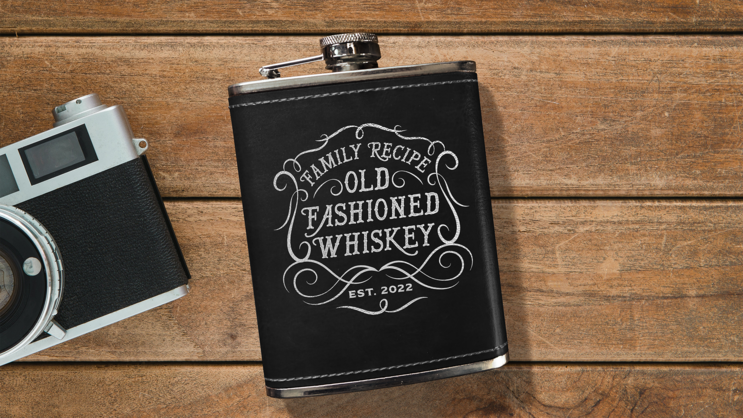 Leatherette flask with logo engraved on it